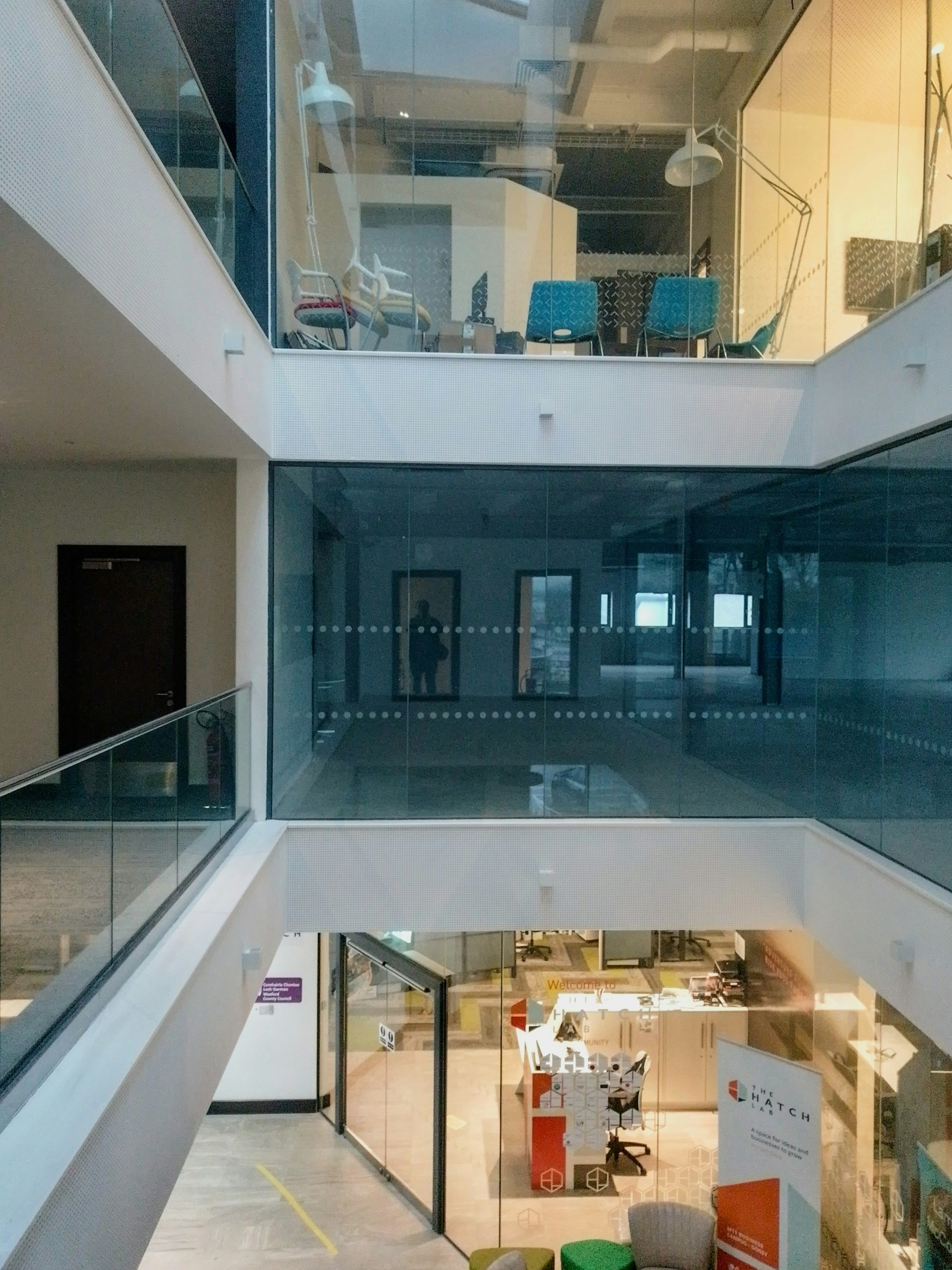 An airy office atrium arranged for focused conversation and collaboration